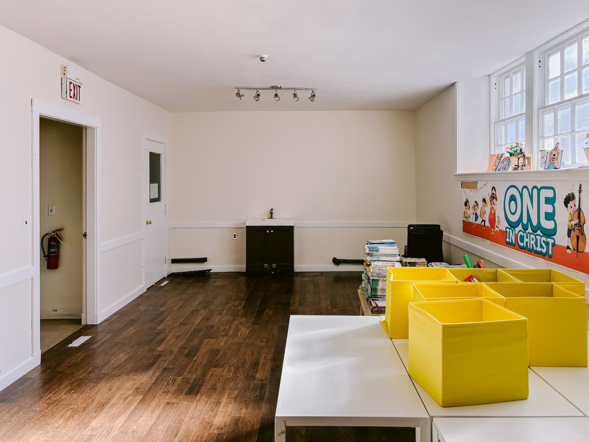 Classroom with sink, windows, and activity tables