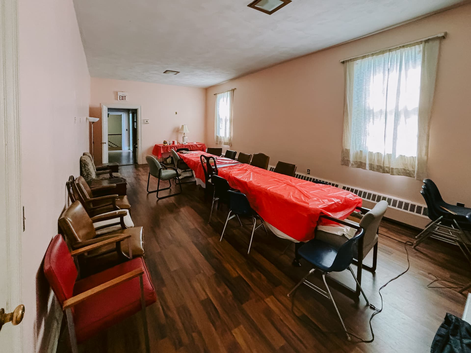 Secondary view of meeting room with windows and seating